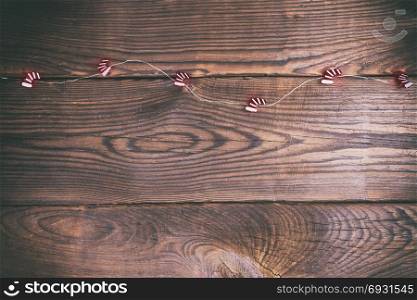 brown wood background and festive garland, empty space at the bottom