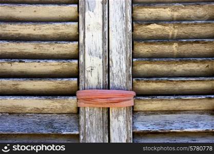 brown wood venetian blind and a pink rope in colonia del sacramento uruguay