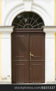 Brown wooden door with arch