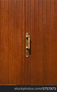 brown wooden door with brass handle