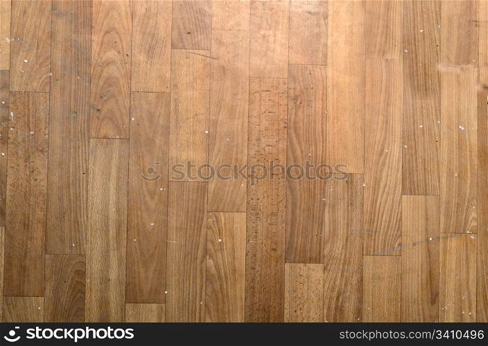 Brown wooden parquet planks covered with different rubbish.