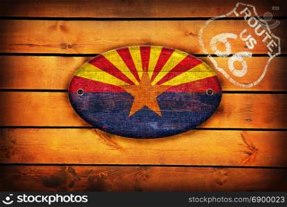 Brown wooden planks with the Arizona flag and shield of Route 66.