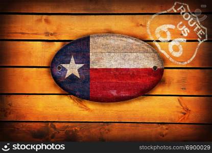Brown wooden planks with the Texas flag and shield of Route 66.
