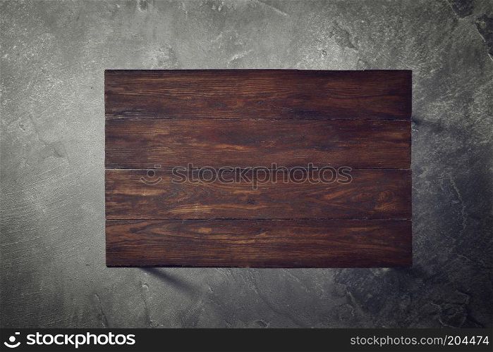 brown wooden table on a concrete background top view flat lay. Wooden table on a concrete background