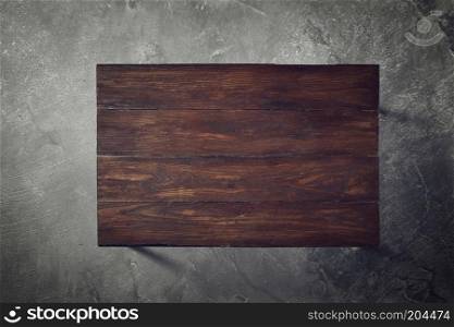 brown wooden table on a concrete background top view flat lay. Wooden table on a concrete background