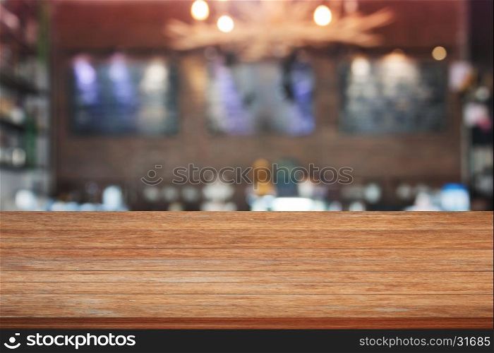 Brown wooden table top with blurred cafe background. product display template