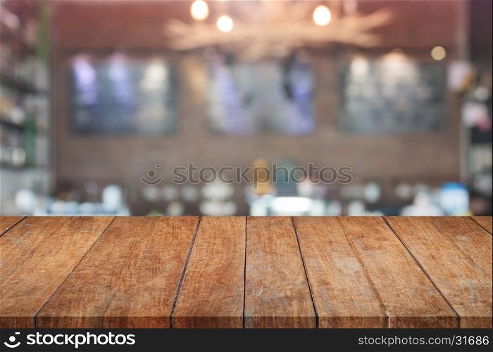Brown wooden table top with blurred cafe. product display template
