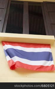 brown wooden window with tinted glass decorating with thailand national flag