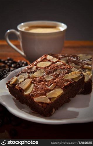 brownie cake and hot coffee on wood table. brownie cake and hot coffee