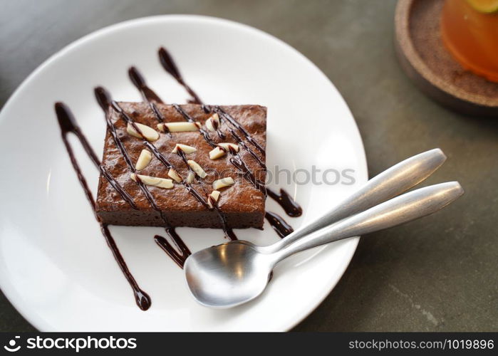 Brownie cake on white plate and spoon