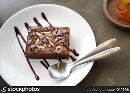 Brownie cake on white plate and spoon