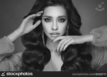 Bru≠tte girl with perfect makeup. Smiling beautiful model woman with long curly hairsty≤. Care and beauty hair∏ucts. Fashionab≤black and white photography