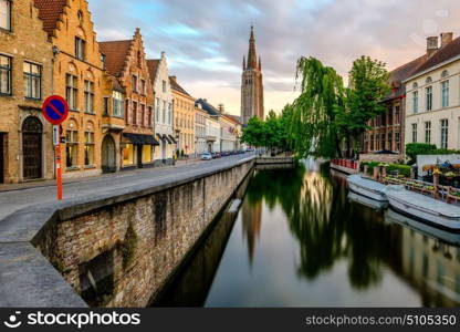 Bruges (Brugge) cityscape with water canal and Church of Our Lady, Flanders, Belgium