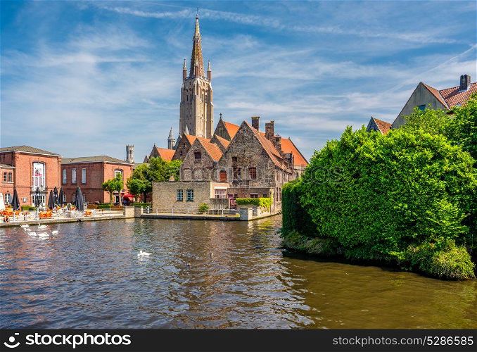Bruges (Brugge) cityscape with water canal and Church of Our Lady, Flanders, Belgium