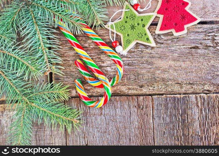 brunch of christmas tree and color candy on wooden background