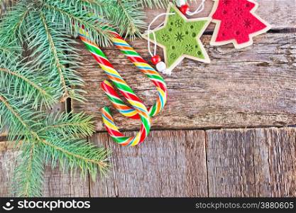 brunch of christmas tree and color candy on wooden background