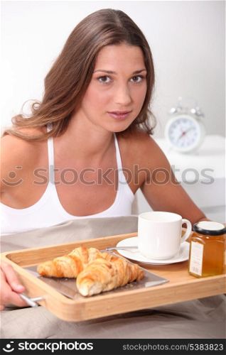 brunet having breakfast in bed