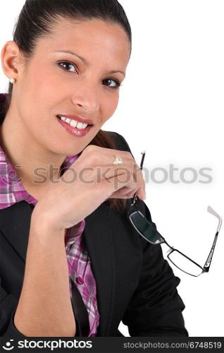brunet woman holding reading glasses