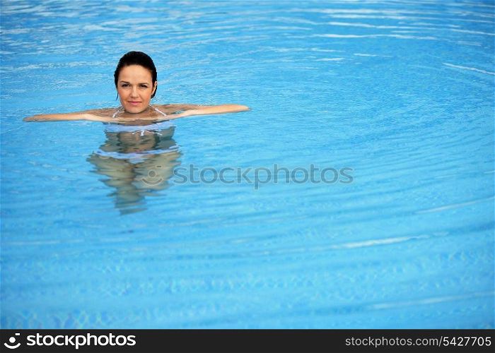 Brunette alone in swimming pool