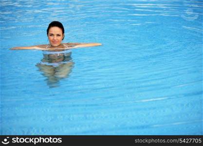 Brunette alone in swimming pool