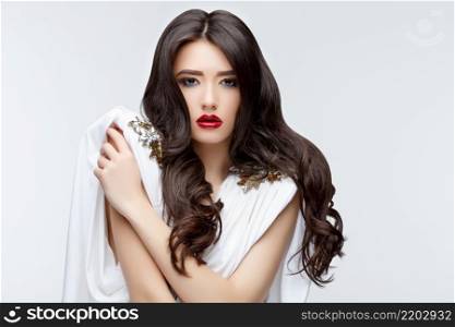 Brunette asian girl with long curly hair. Studio shot. Brunette asian girl with long curly hair