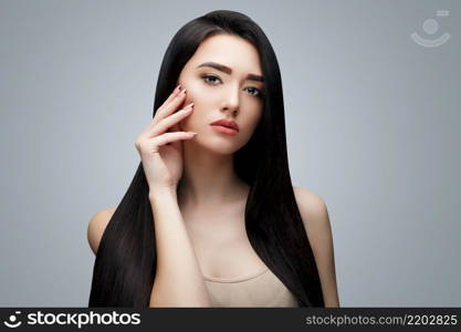 Brunette asian girl with long straight hair. Studio shot. Brunette asian girl with long straight hair