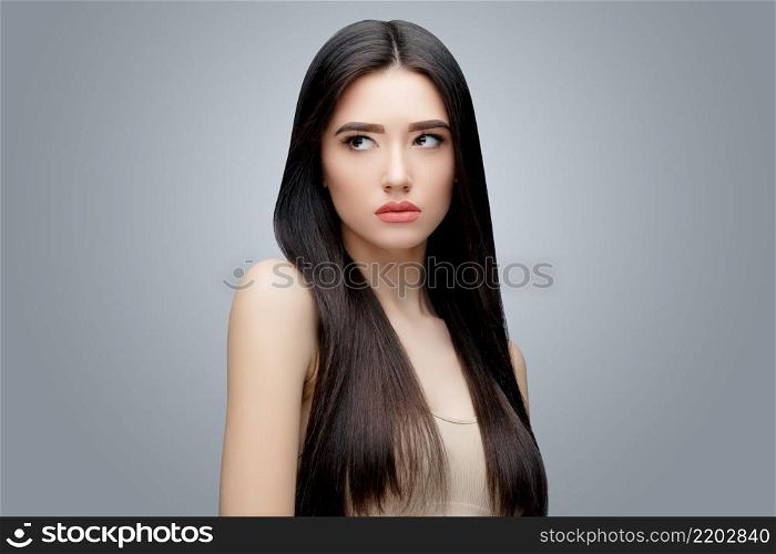Brunette asian girl with long straight hair. Studio shot. Brunette asian girl with long straight hair
