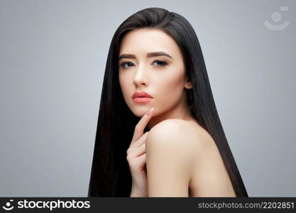 Brunette asian girl with long straight hair. Studio shot. Brunette asian girl with long straight hair