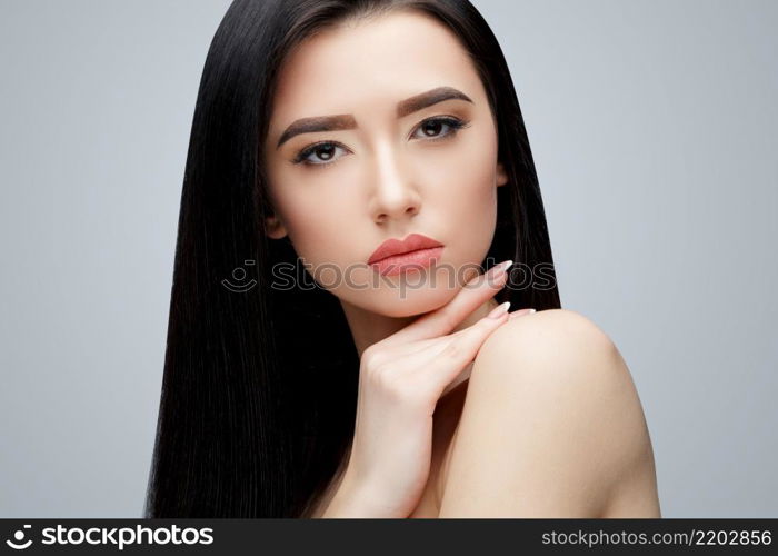 Brunette asian girl with long straight hair. Studio shot. Brunette asian girl with long straight hair