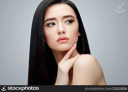 Brunette asian girl with long straight hair. Studio shot. Brunette asian girl with long straight hair