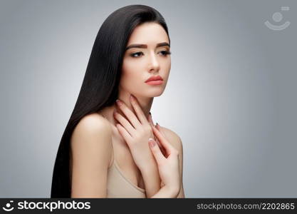 Brunette asian girl with long straight hair. Studio shot. Brunette asian girl with long straight hair