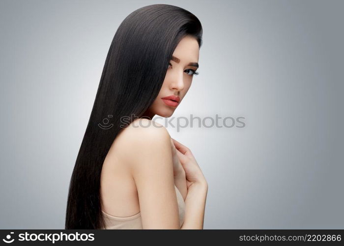 Brunette asian girl with long straight hair. Studio shot. Brunette asian girl with long straight hair