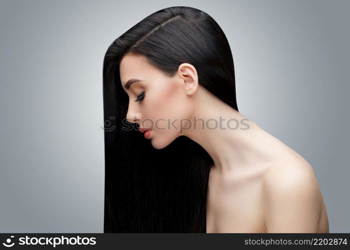 Brunette asian girl with long straight hair. Studio shot. Brunette asian girl with long straight hair