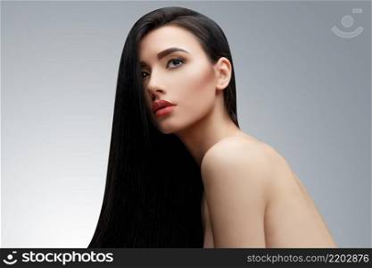 Brunette asian girl with long straight hair. Studio shot. Brunette asian girl with long straight hair