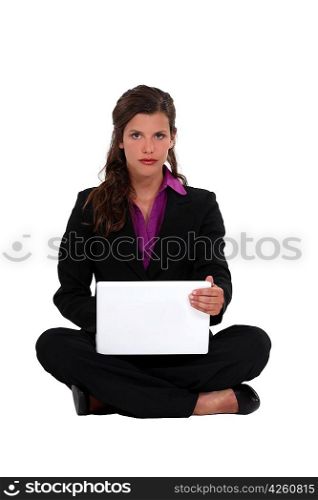 Brunette businesswoman sat cross-legged on the floor