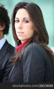 Brunette businesswoman stood by colleague