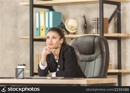 brunette businesswoman thinking her office