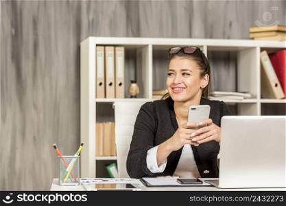 brunette businesswoman using her smartphone 2