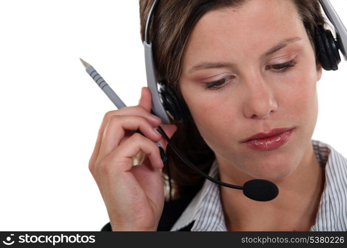 Brunette call-center worker listening to customer
