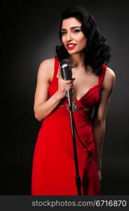 Brunette chanteuse in a vintage red dress