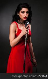 Brunette chanteuse in a vintage red dress