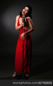 Brunette chanteuse in a vintage red dress