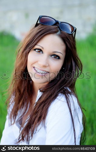 Brunette cool girl with brackets in the park