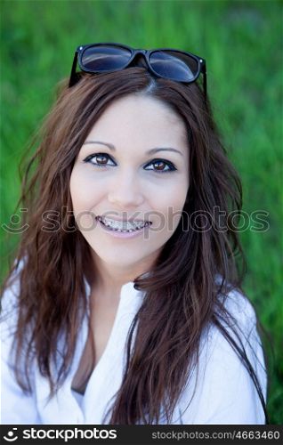 Brunette cool girl with brackets in the park