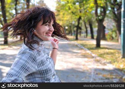 brunette Cute young woman dancing outdoors in nature