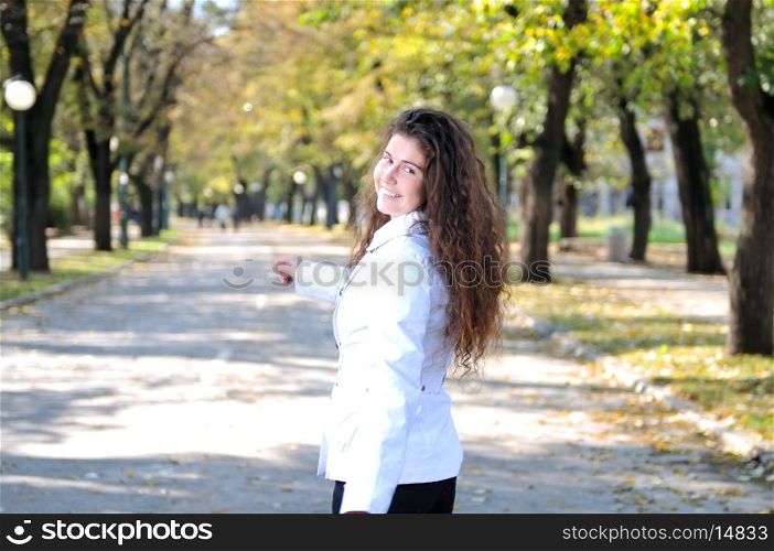 brunette Cute young woman smiling outdoors in nature