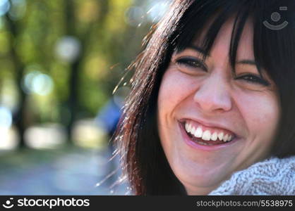 brunette Cute young woman smiling outdoors in nature