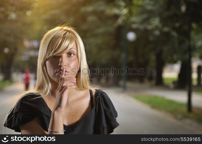 brunette Cute young woman with colorful scarf posing outdoors in nature