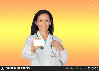 Brunette doctor with a blank card with a yellow and orange background