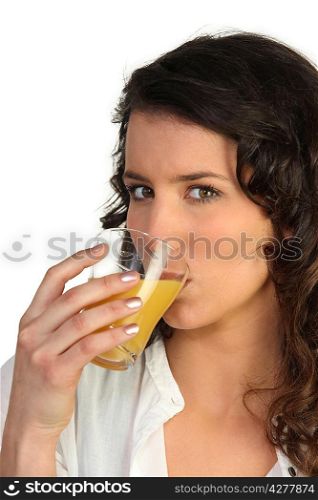 Brunette drinking glass of juice